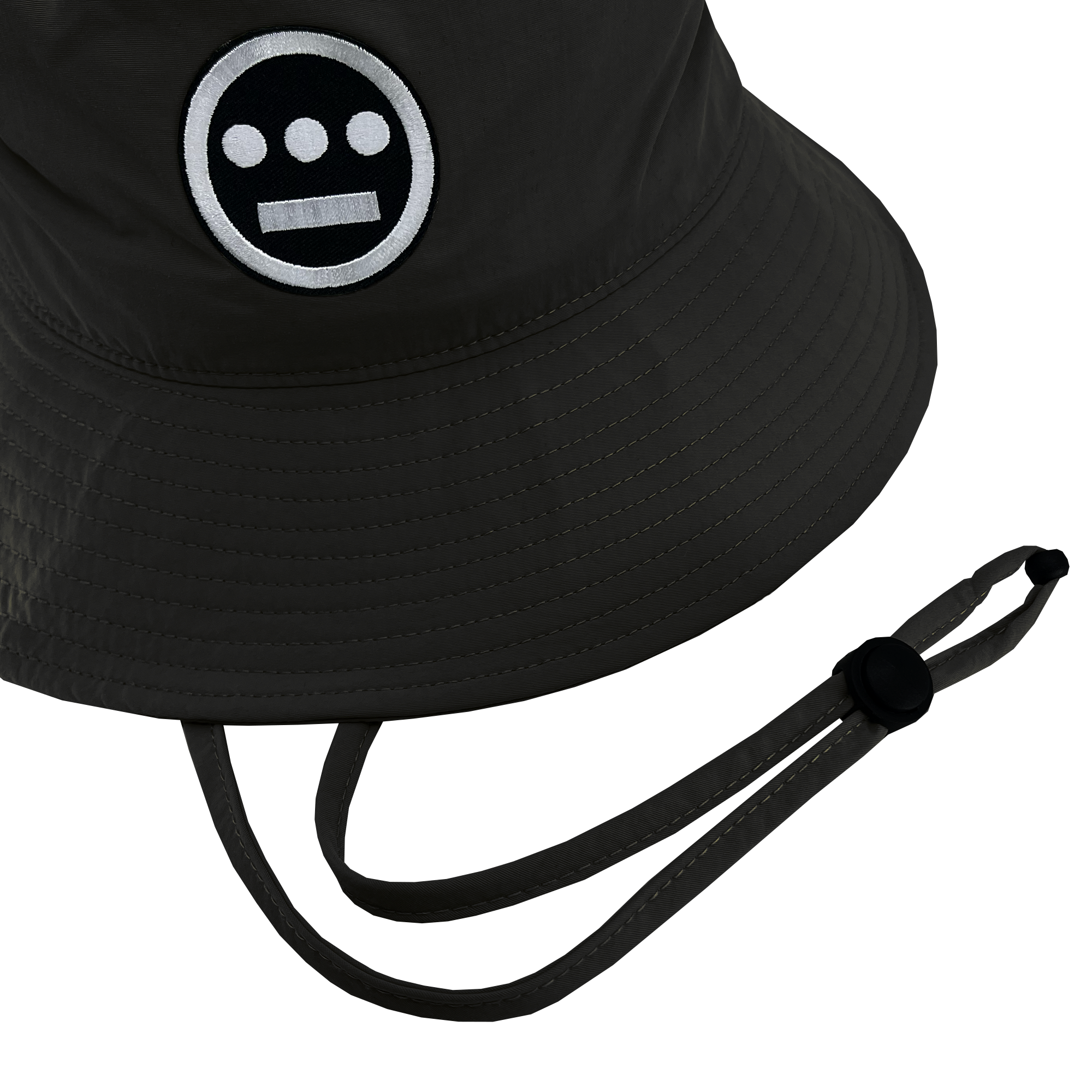 The Hiero Boonie Hat by Hieroglyphics is a dark-colored bucket hat crafted from recycled nylon, featuring a logo with a circular face, two white eyes, and a horizontal bar for a mouth. It includes a chin strap with an adjustable toggle, and the stitching and texture of the fabric are visible.