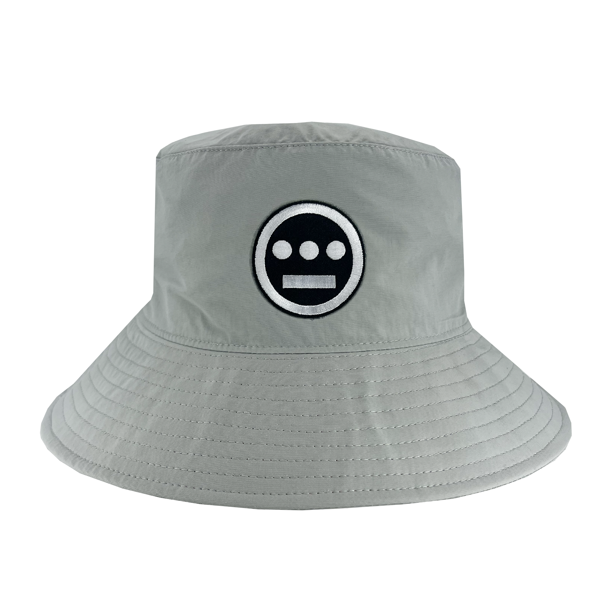 The Hiero Boonie Hat by Hieroglyphics is a light gray bucket hat crafted from recycled nylon, featuring a black and white embroidered logo on the front. The logo includes a black circle with three horizontal white dashes and a solid white line. The hat has a downward-sloping brim with visible stitching around the edge, evoking modern hieroglyphics.