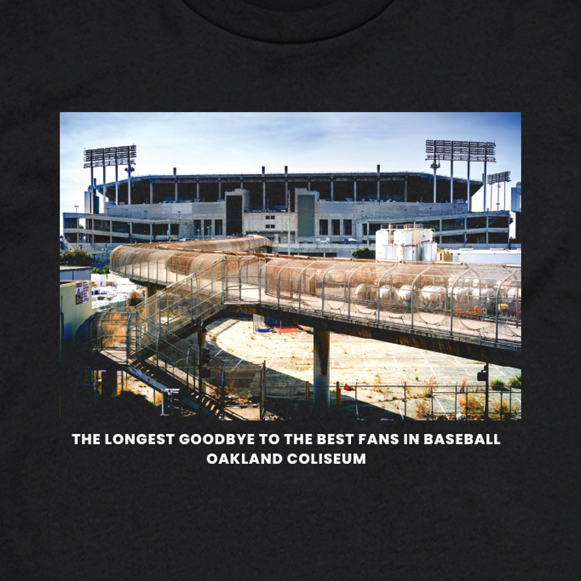 An exterior view of an empty Oakland Coliseum, with a fenced walkway leading towards the stadium. The text below the image reads, "The Longest Goodbye to the best fans in baseball, Oakland Coliseum." Once buzzing with lively tailgate parties and $2 beers, the scene now appears abandoned with overgrown grass and no people present. Presented by Oaklandish.