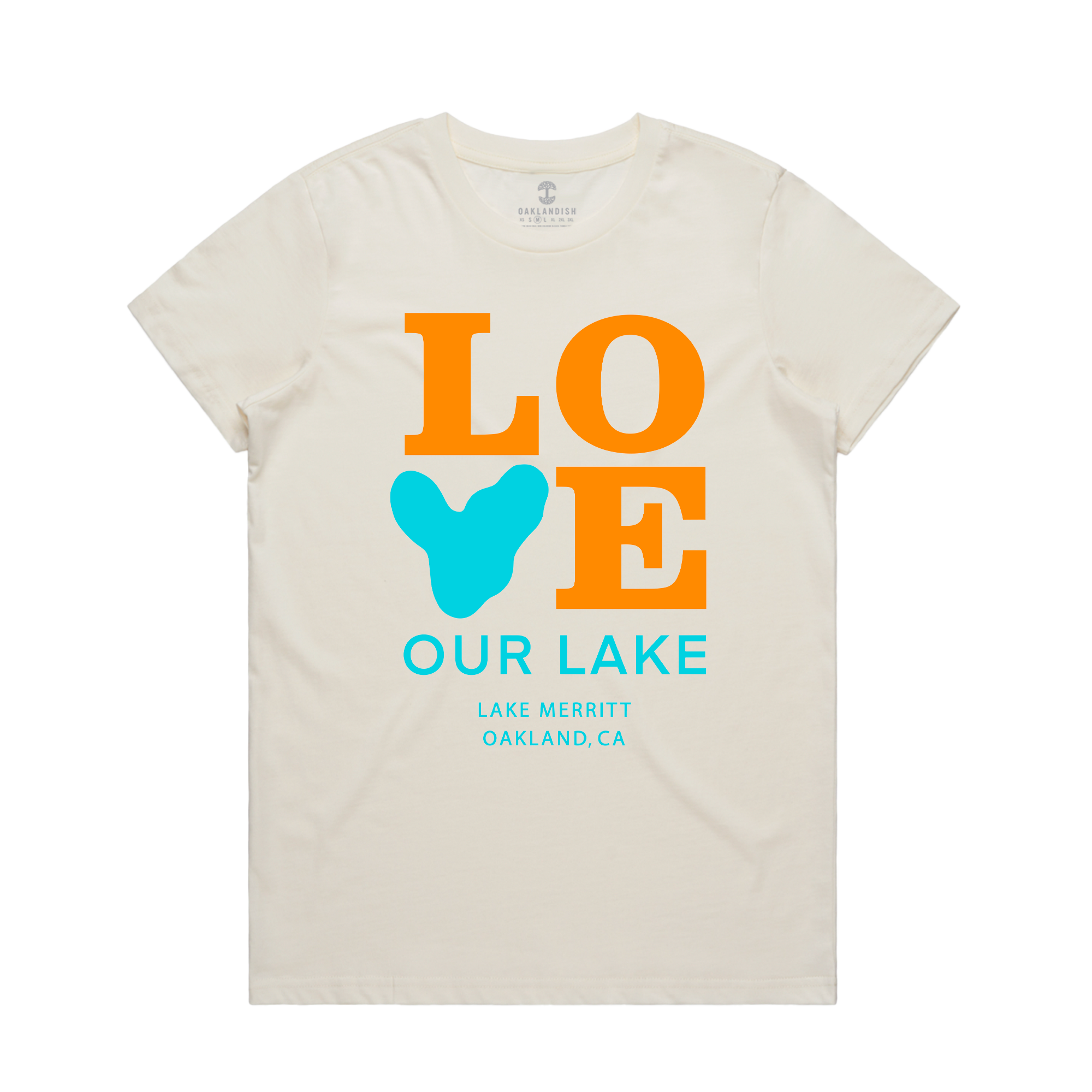 The Women's Love Our Lake Tee by Oaklandish is a cream-colored T-shirt featuring bold, large text reading "LOVE" with the "V" shaped like a blue lake. Below, smaller text reads "OUR LAKE" in blue, followed by "LAKE MERRITT OAKLAND, CA," also in blue. This shirt supports a community campaign centered around Lake Merritt in Oakland.