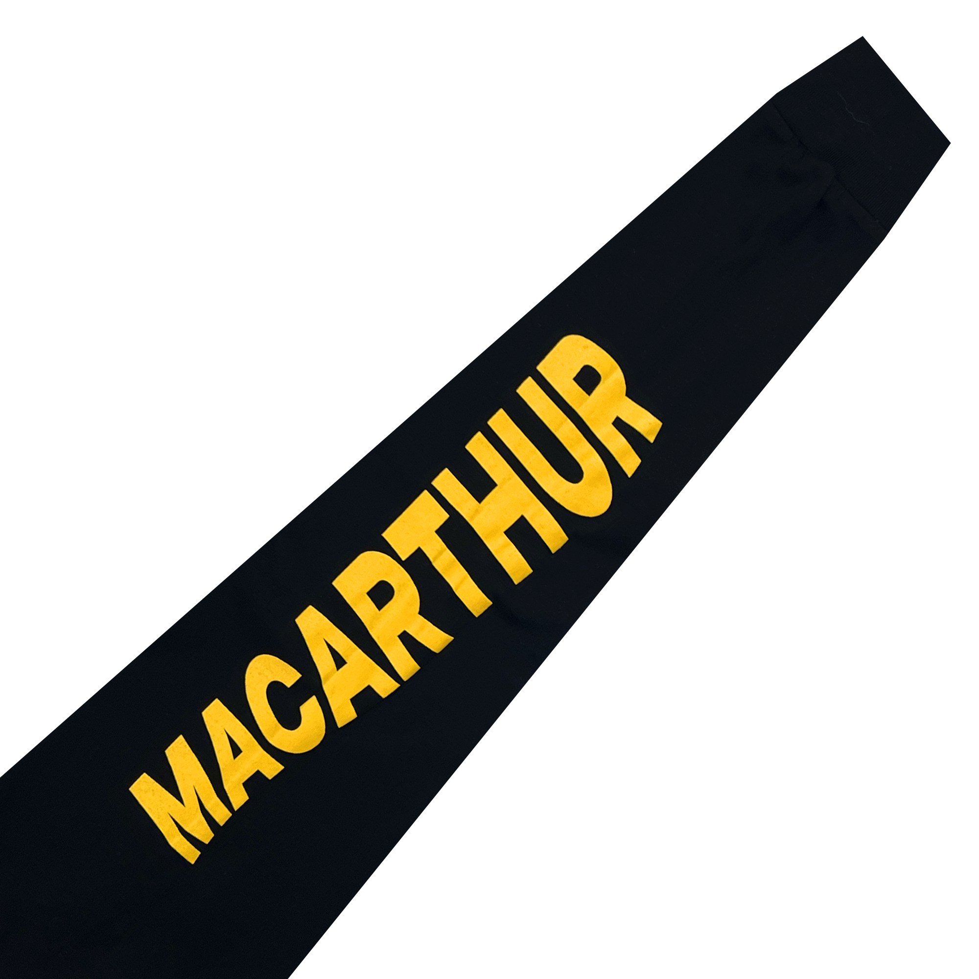 A black pennant prominently displays the word "MACARTHUR" in bold, uppercase yellow letters. The text is slightly angled and spans horizontally across the pennant, echoing the design simplicity of the MacArthur Maze x Oaklandish LS Tee by Oaklandish. The tip of the pennant is not visible in the image, with no additional images or decorations present.