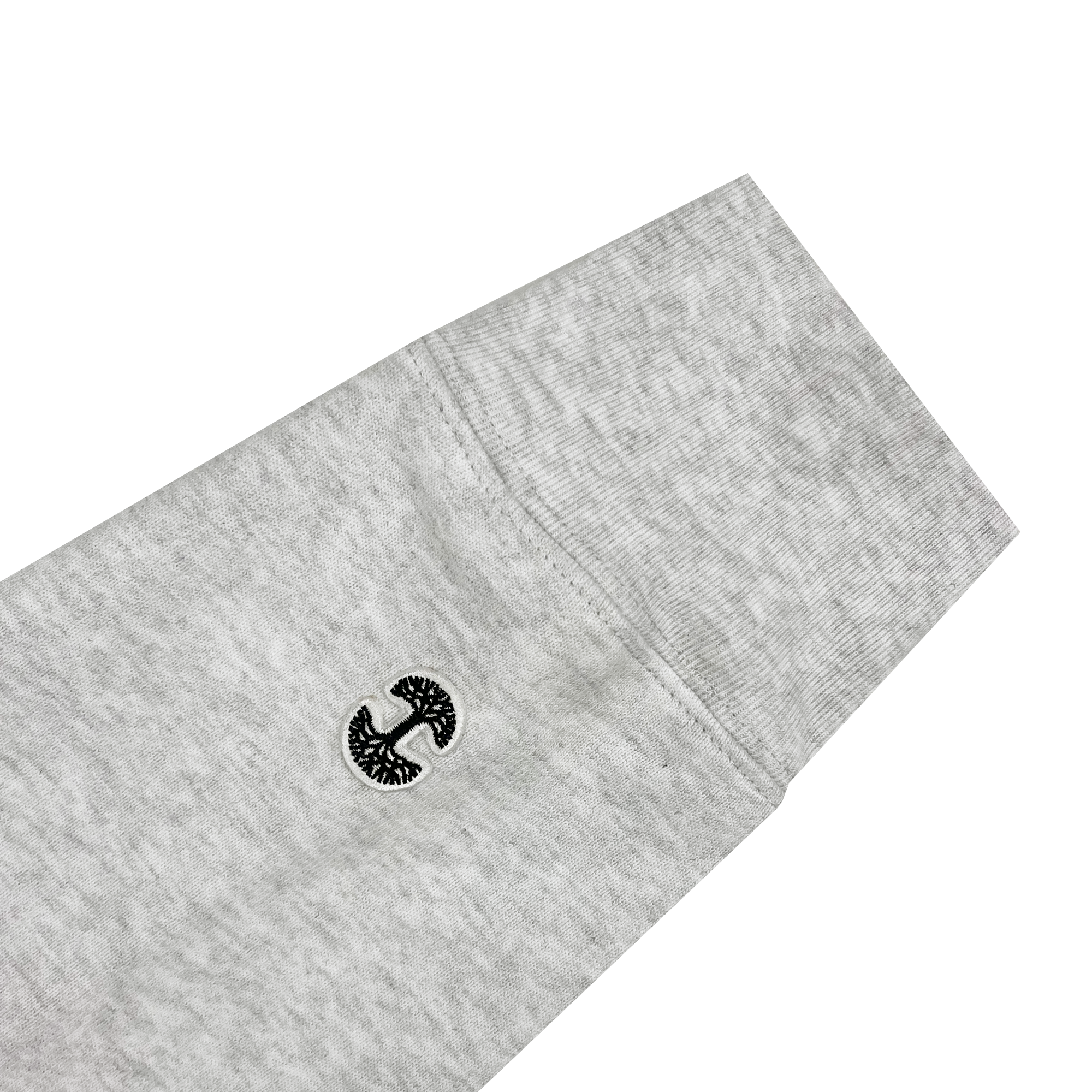 Detailed view of grey pullover hoodie sleeve with mini woven Oaklandish tree logo near left cuff.