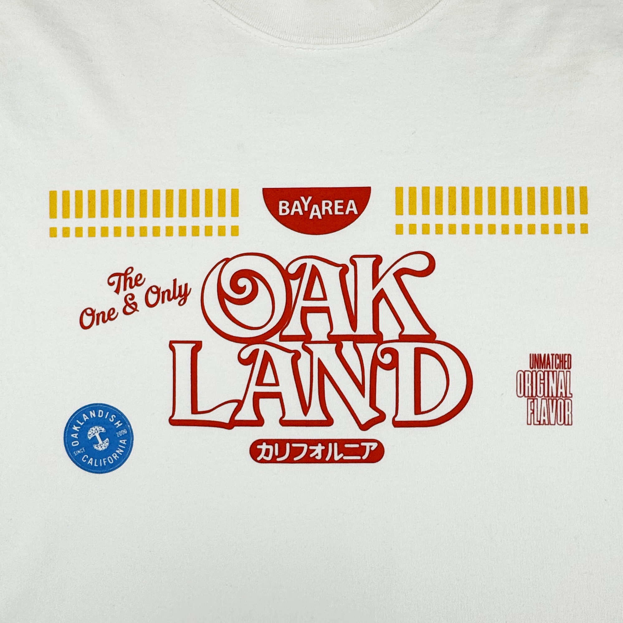 The Oaklandish Noodles Tee is a white 100% cotton men’s t-shirt with “OAKLAND” and “The One & Only” in bold red, “BAY AREA” on top, yellow lines, a blue Oaklandish seal, red stamp, and Japanese text at the bottom.