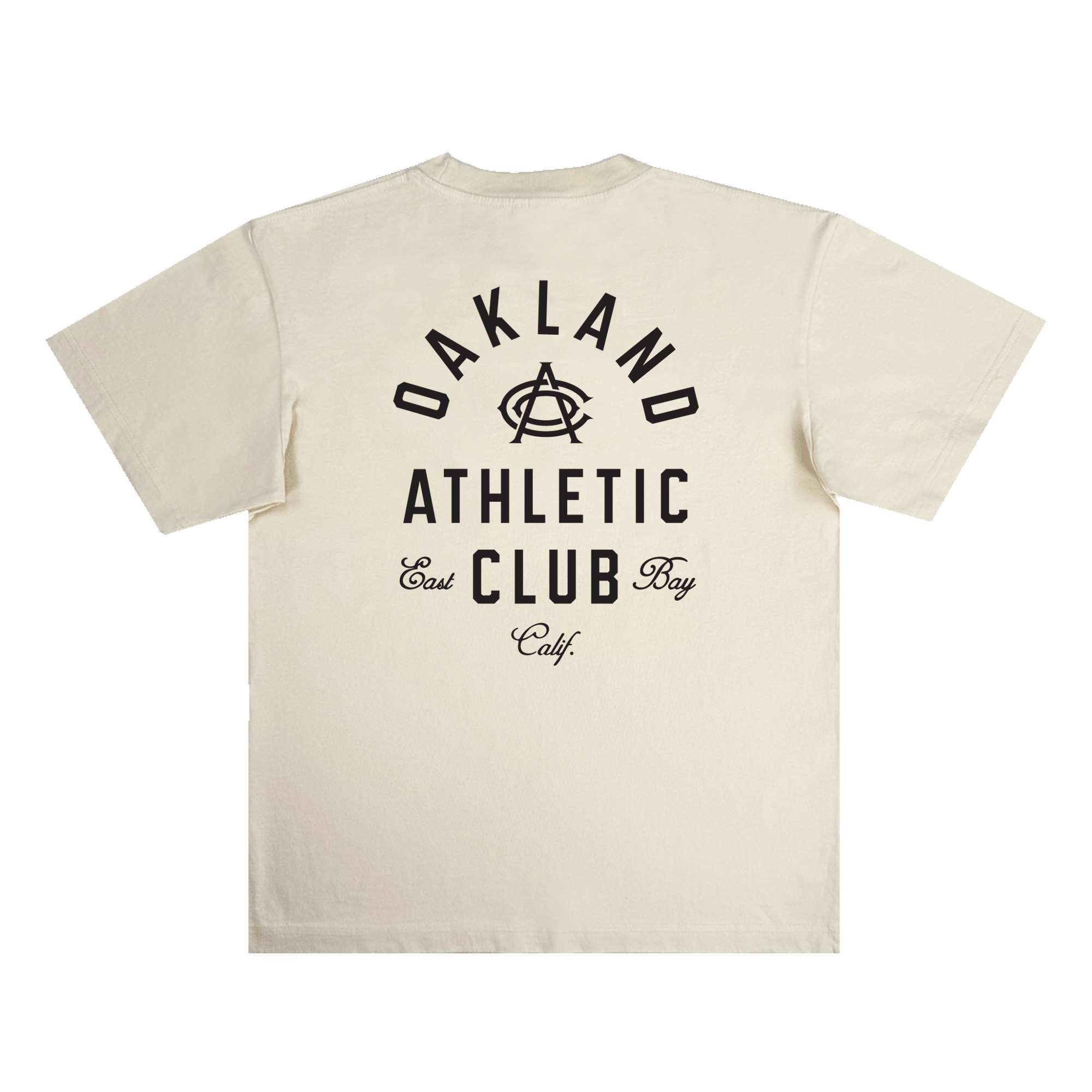 The OAC Tee by OAC is a cream-colored, classic fit t-shirt made from heavy-weight cotton. It features bold black text on the back that reads “OAKLAND ATHLETIC CLUB East Bay Calif.” with a stylized interlocking “A” and “C” at the center. The shirt is displayed flat against a white background.