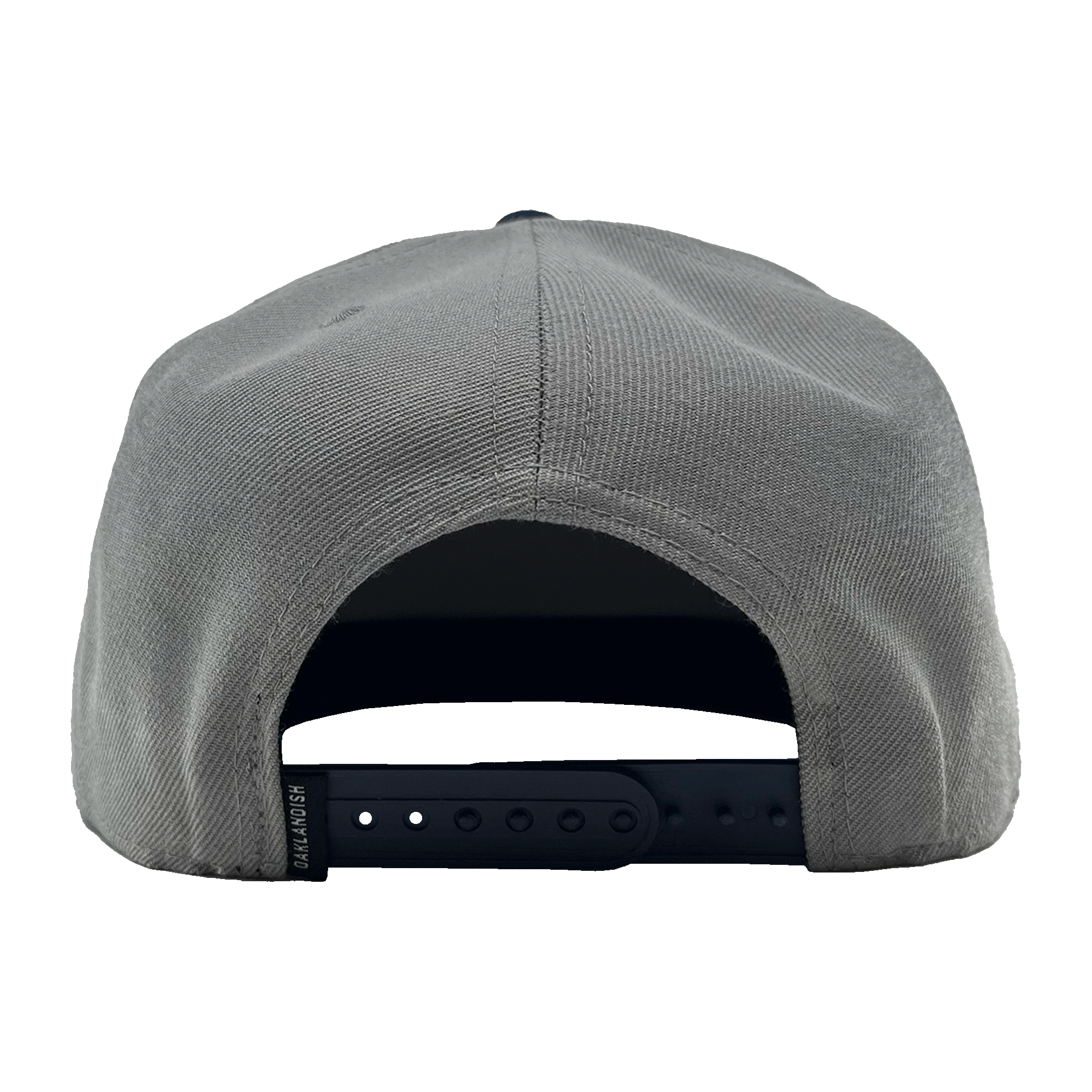 Rear view of the OAK Monogram Snapback in gray with an adjustable black snap closure. The fabric has a textured appearance, and the snap closure offers several adjustment holes. The inside of the back panel shows a partially visible sweatband. Simplistic in design, this cap features an embroidered OAK logo from Oaklandish.