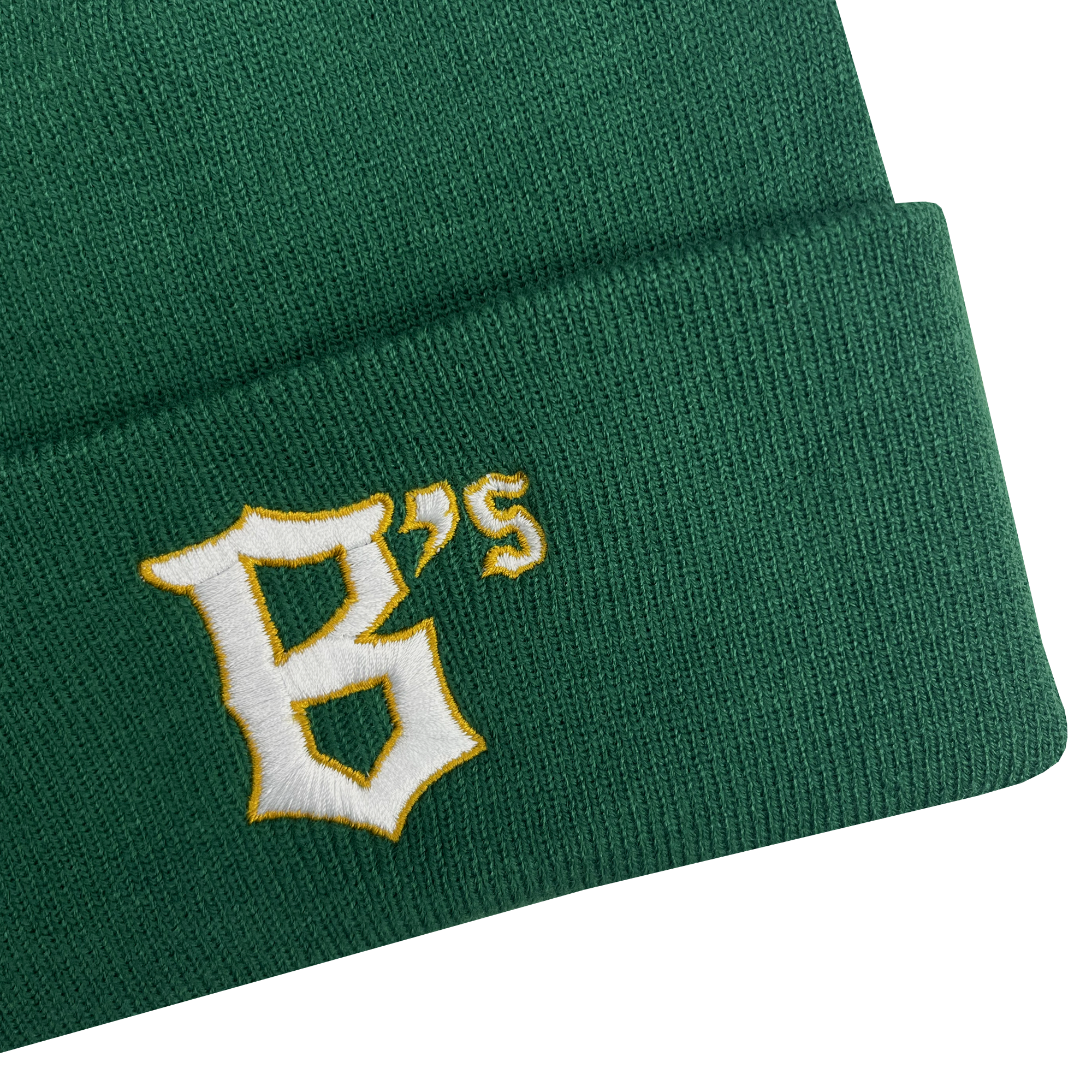 A close-up image of the Oakland Ballers Logo Beanie, a green knit hat with the letters "B's" embroidered on the fold to represent the Oakland Ballers professional baseball team. The text features a white, stylized font with a yellow outline. The beanie’s texture and stitching are clearly visible against the plain, light gray background.