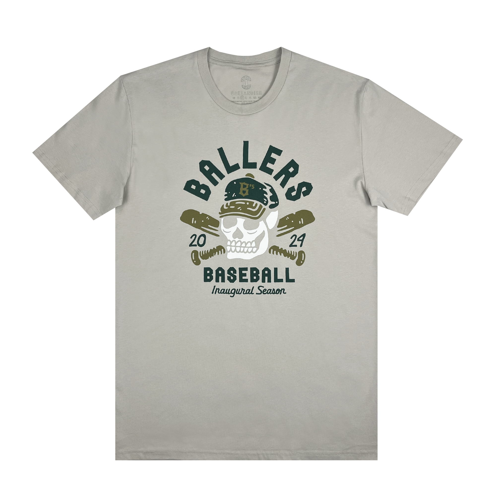 Introducing the "Oakland Til I Die Tee" by Oakland Ballers: This gray t-shirt showcases a striking graphic of a skull adorned in a baseball cap and sunglasses, with crossed baseball bats positioned behind it. The top of the design reads "Oakland Ballers" and "Baseball," while the bottom commemorates "2024" and "Inaugural Season." Celebrating Oakland's new pro baseball team, this tee features a classic round neckline and short sleeves.