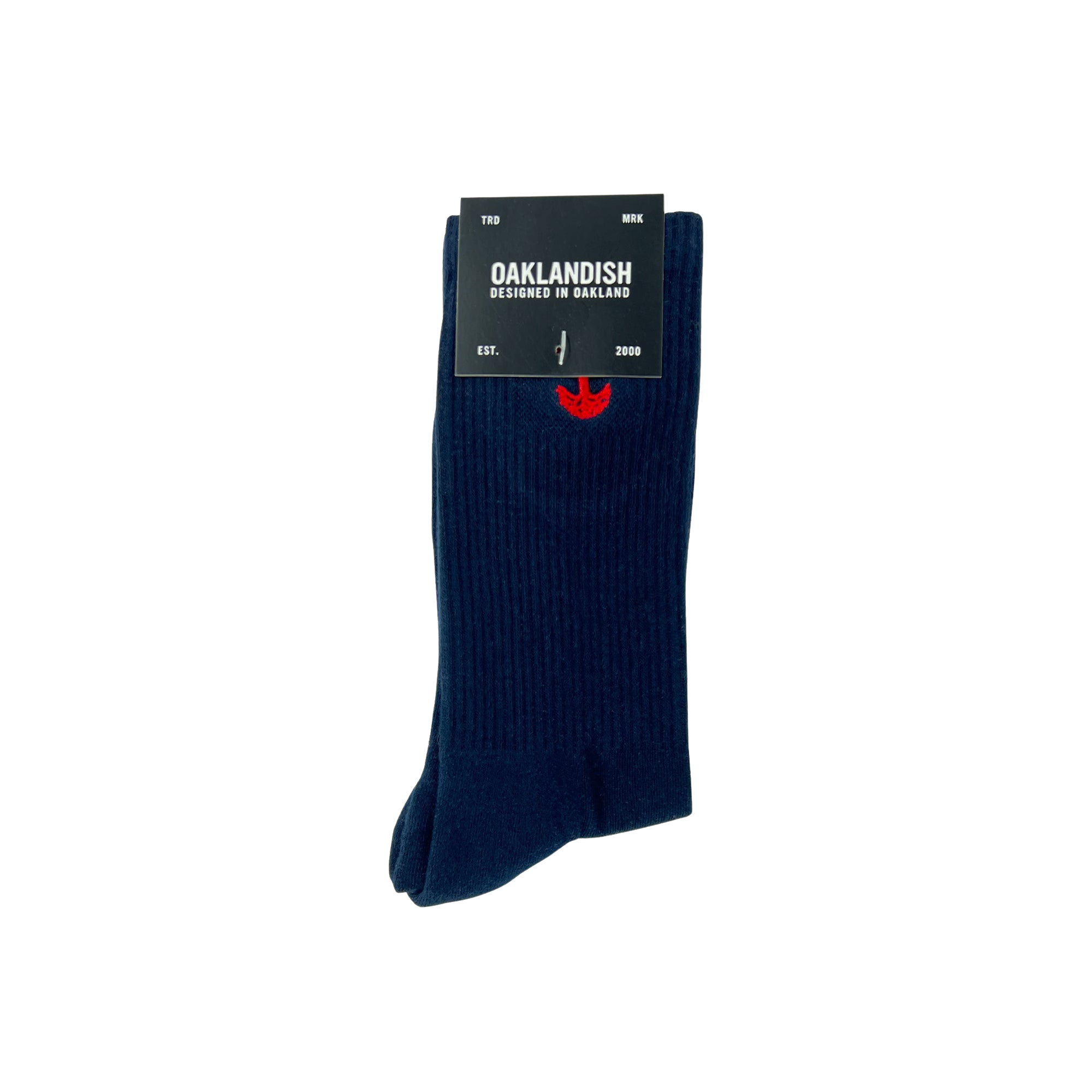 A pair of dark blue Embroidered Logo Socks is neatly folded, secured with a black label that reads, "OAKLANDISH, Designed in Oakland" with "EST. 2000" below. The adult-sized socks feature a subtle red embroidered Oaklandish logo near the top and have a ribbed texture.
