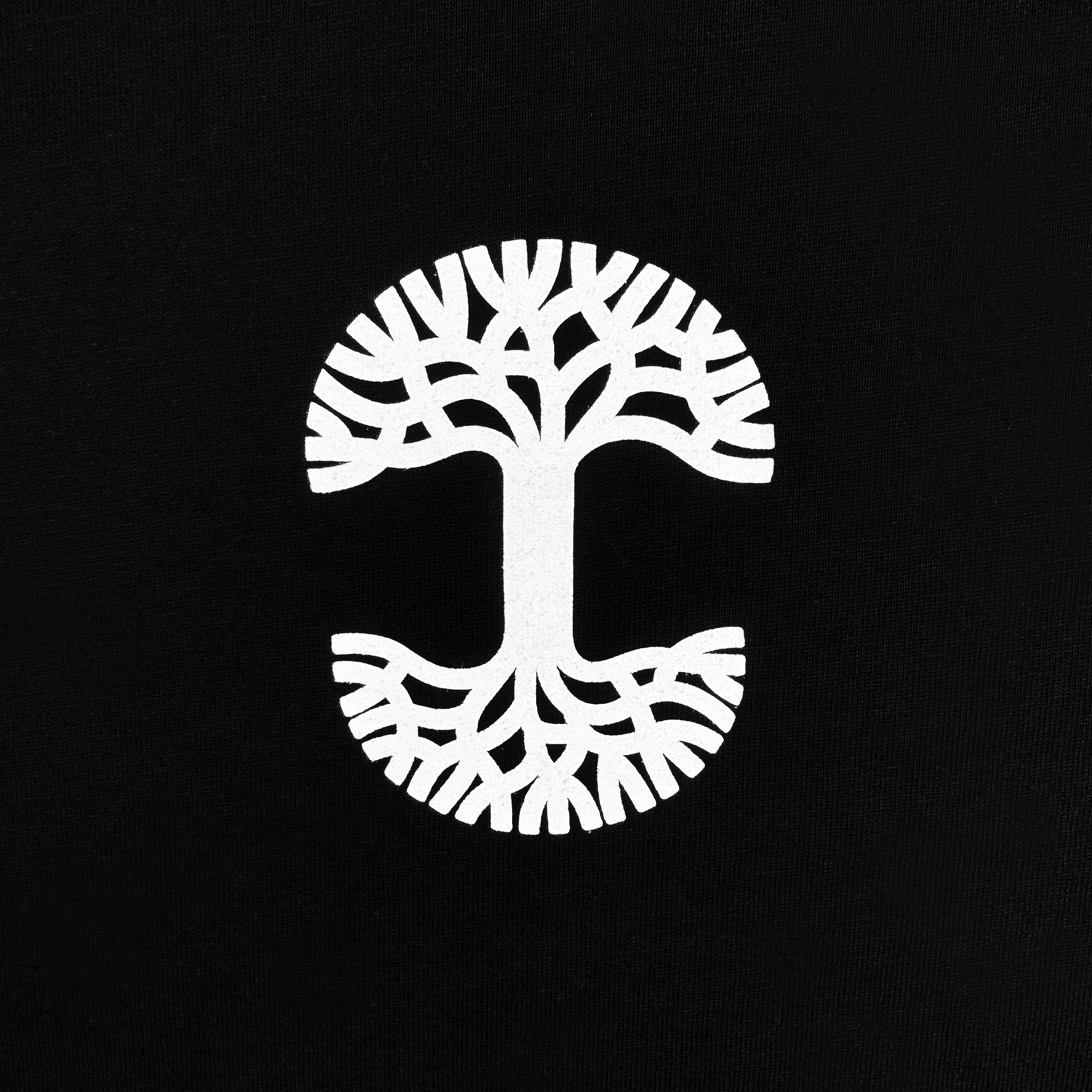 The Posy Tee from Oaklandish features a symmetrical and stylized white tree design that forms a circular shape on a black cotton t-shirt. Its branching patterns extend both upwards and downwards, resembling roots and branches to create a balanced, mirror-like appearance in the men's collection.