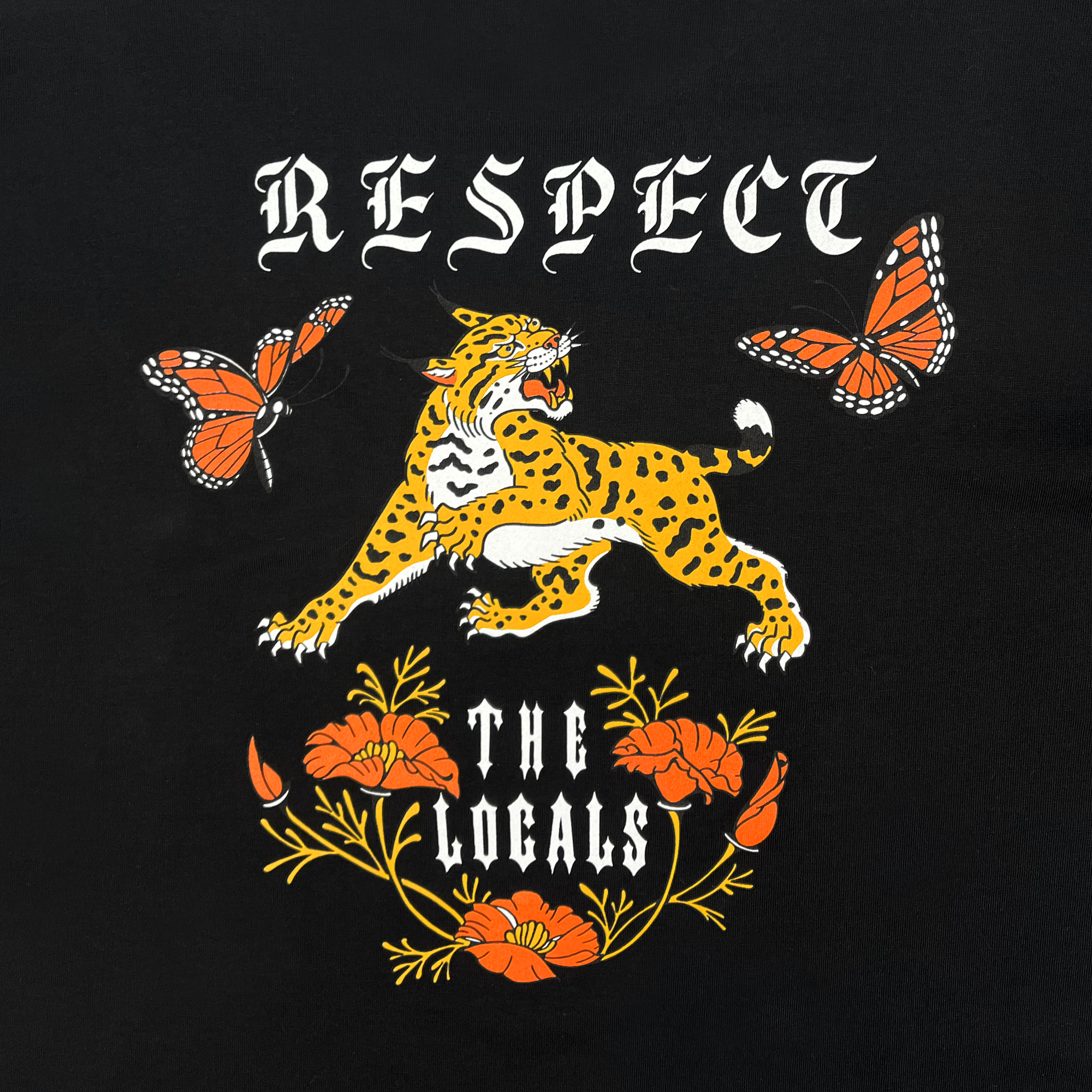 The image showcases the "Respect the Locals LS Tee" by Oaklandish, a 100% cotton long sleeve t-shirt. The design includes the text "RESPECT THE LOCALS" in an ornate white font, with an illustration of a leaping leopard surrounded by two orange butterflies above it. Below the text, several orange poppy flowers with green stems stand out against the black background.