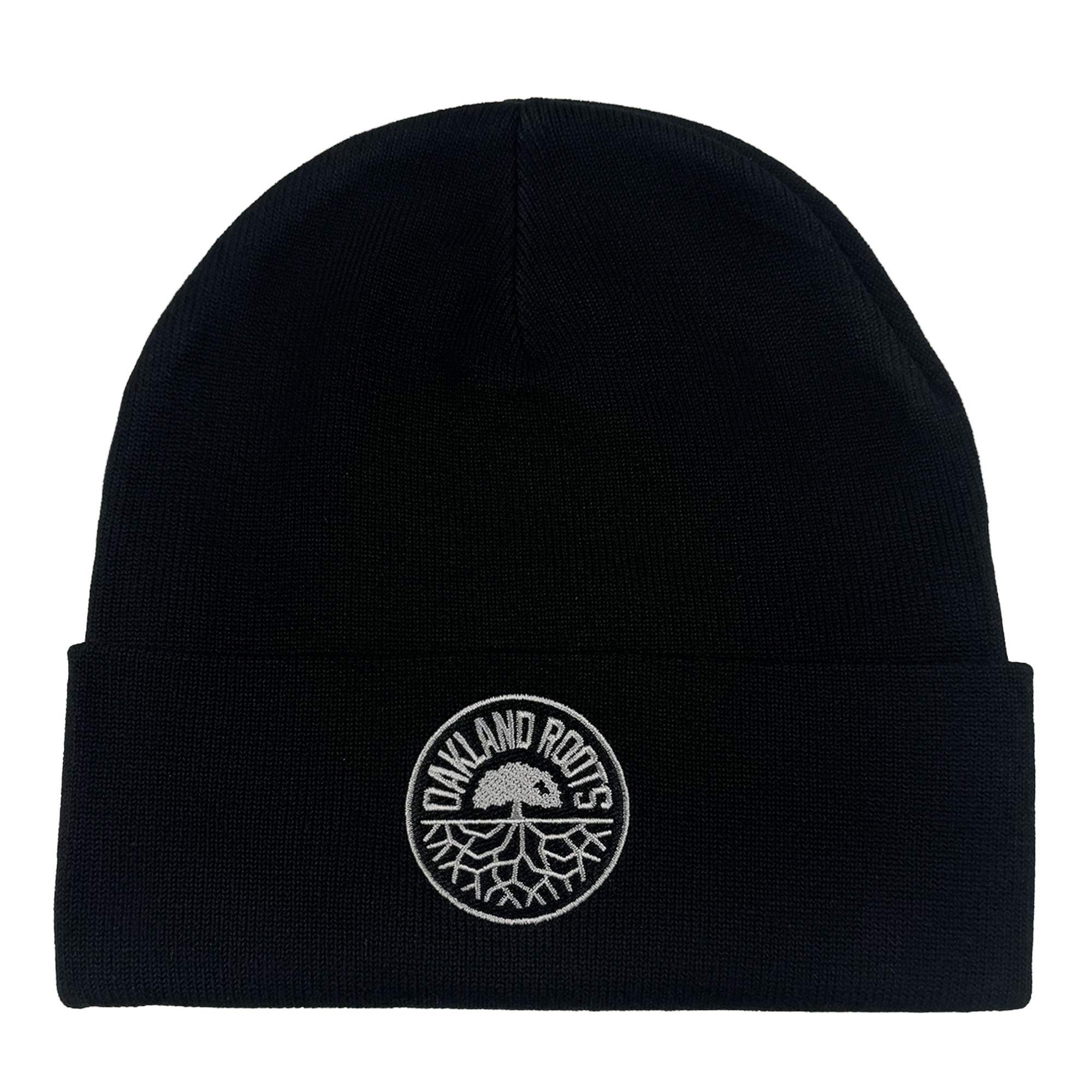 The ORSC Beanie by Oakland Roots SC is a black knit hat with a folded brim and a circular white patch on the front featuring "OAKLAND ROOTS" and the club’s tree logo. The background is plain white.