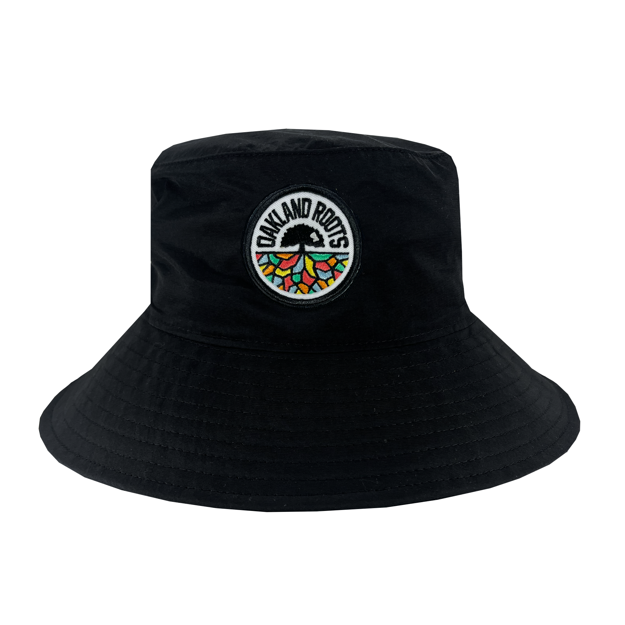 The Oakland Roots SC Boonie Hat, by Oakland Roots SC, is a black bucket hat crafted from recycled nylon. It showcases an embroidered circular patch on the front that reads "OAKLAND ROOTS" encircling a stylized tree with vibrant geometric roots in red, orange, yellow, and green. The overall design is bold and eye-catching.