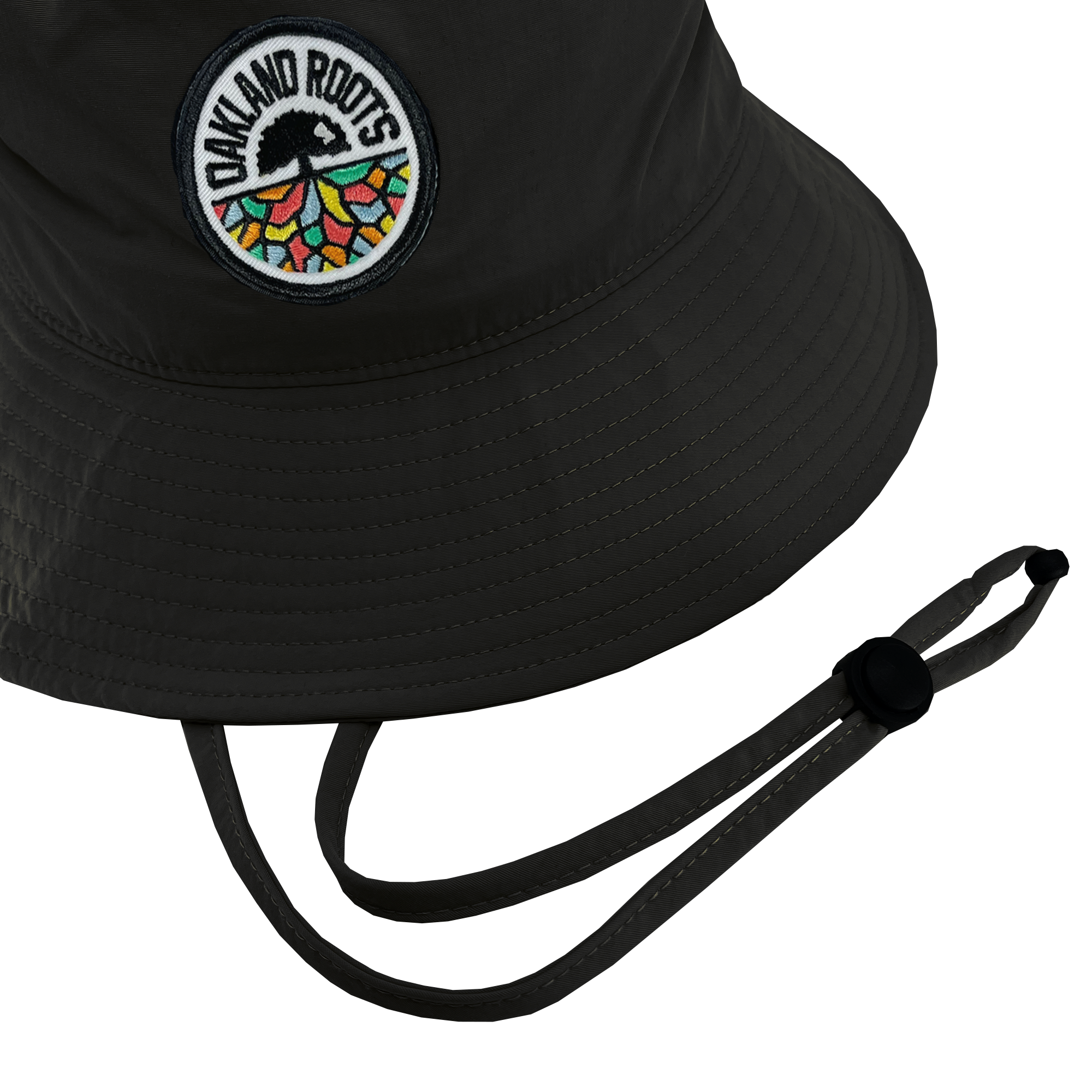 The Oakland Roots SC Boonie Hat from the Oakland Roots SC brand features a black color and displays the "Oakland Roots Sports Club" logo on the front, showcasing a tree with colorful geometric shapes forming the roots. Made from recycled nylon, it includes a stitched brim and an adjustable chin strap with a plastic toggle for securing, all set against a white background.