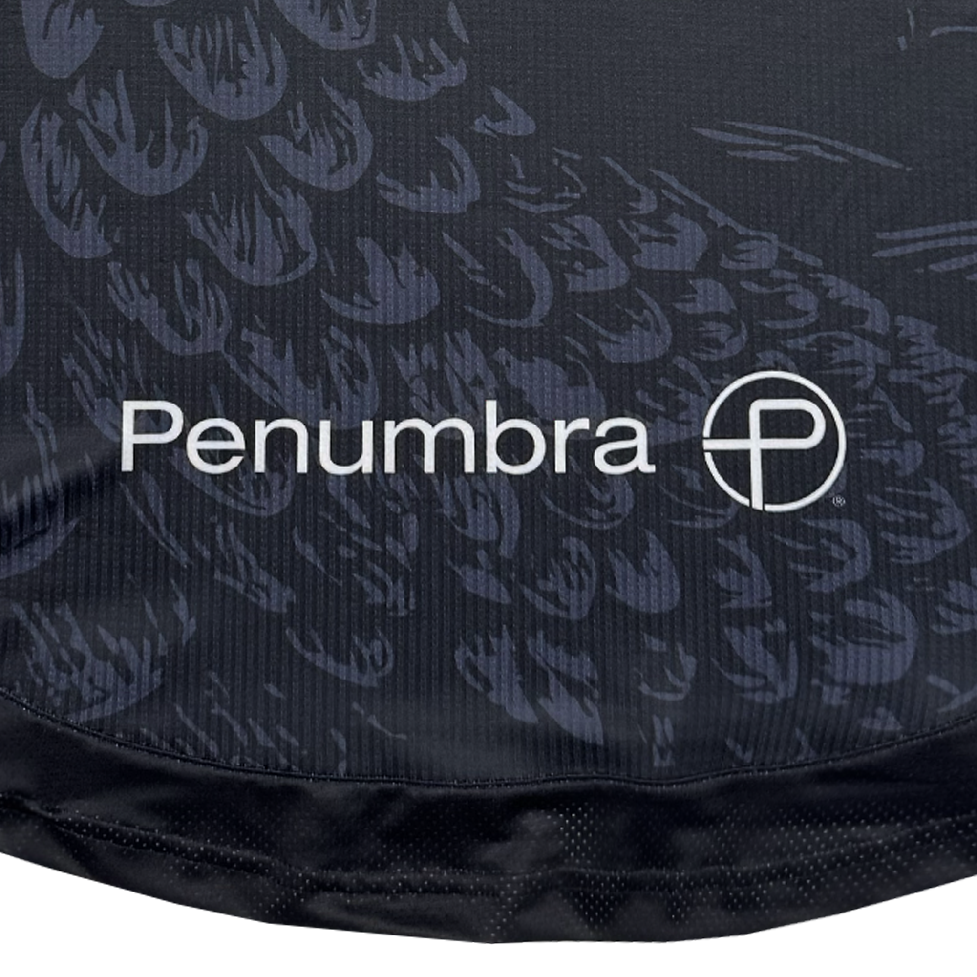 A close-up of dark fabric from the Oakland Roots SC Custom Unisex Oak-ness Awakens Kit displays the white logo and circular “P,” inspired by Lake Merritt’s Oak-ness Monster folklore.