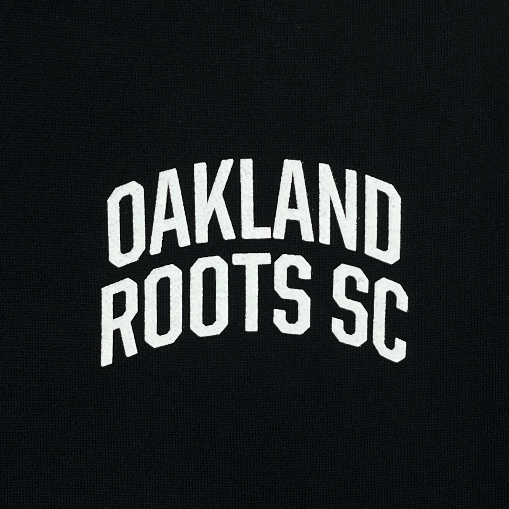 The Oakland Roots SC Logo 2.0 Hoodie by Other features bold, white text that reads "OAKLAND ROOTS SC" centered on a black background in an arched formation, reflecting the club's commitment to social good and community spirit with its clean and striking visual contrast.