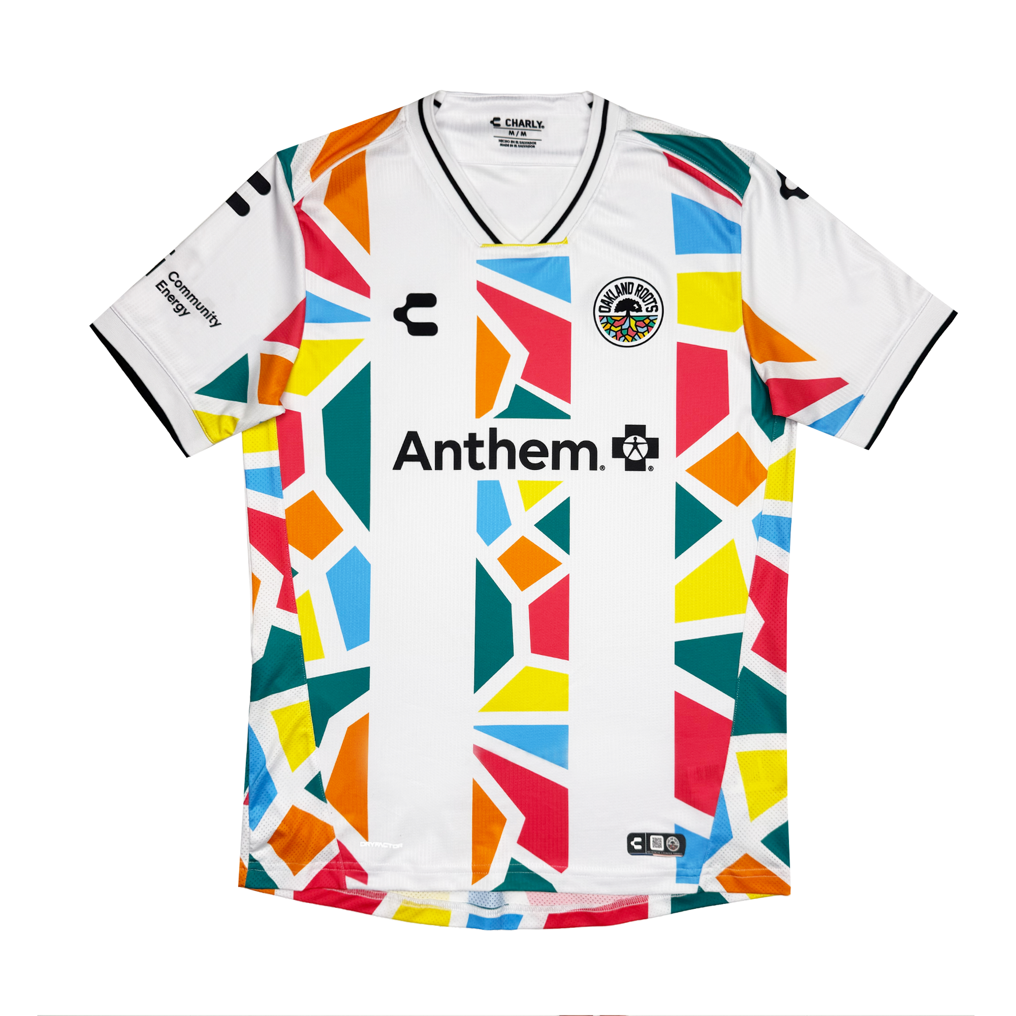 The Unisex Mosaic in Motion Kit by Oakland Roots SC is a white jersey with a black V-neck and sleeve trim, colorful geometric shapes, “Anthem.” and logo on the chest, an Oakland Roots 2026 rainbow badge, and sponsor logos on the sleeves.