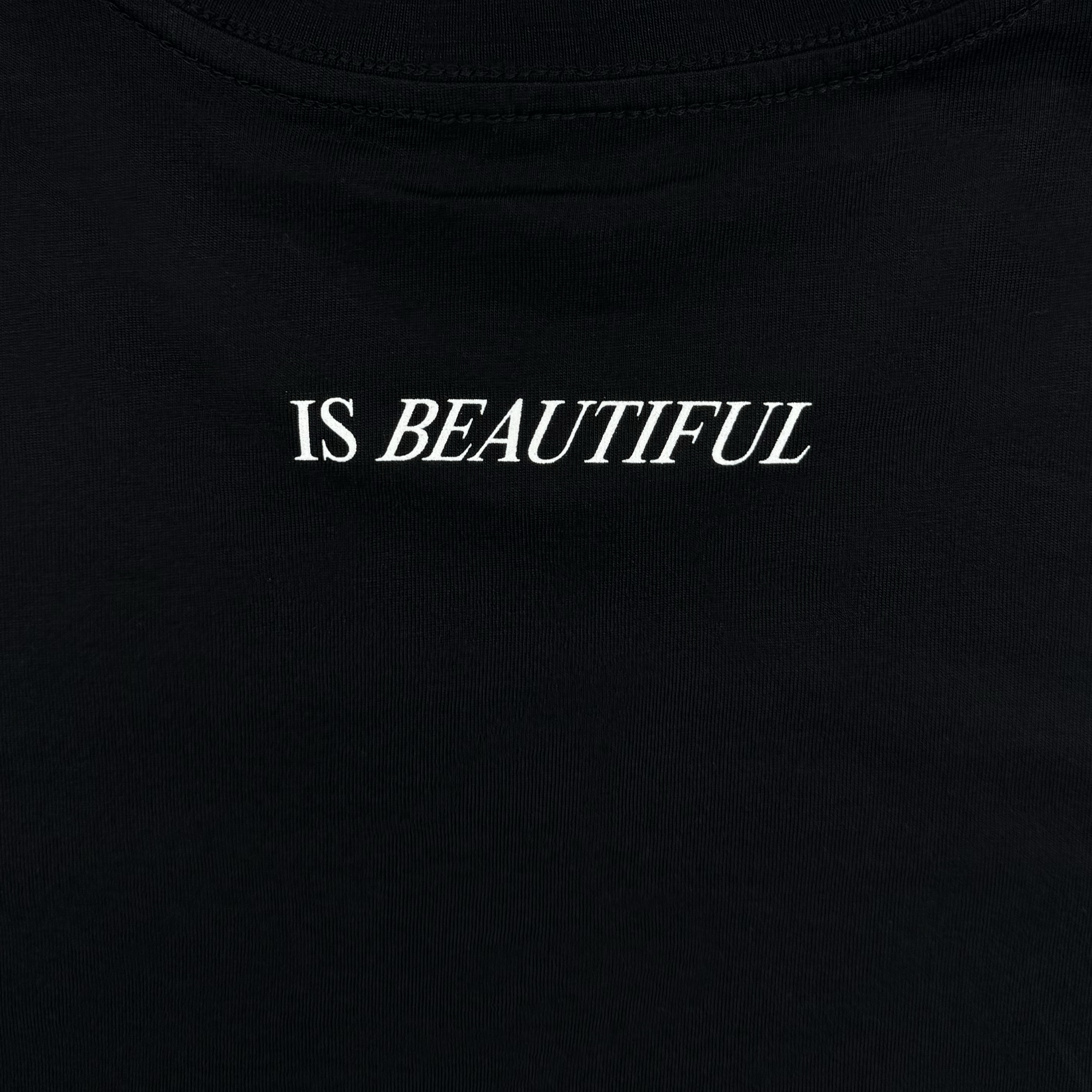 The "Skateboarding is Beautiful Tee" by Oaklandish features bold white capital letters spelling "IS BEAUTIFUL" centered on the front, providing a striking contrast against its black fabric—ideal for those who embrace Oakland's vibrant skateboarding culture. The rest of the T-shirt is plain and unadorned.