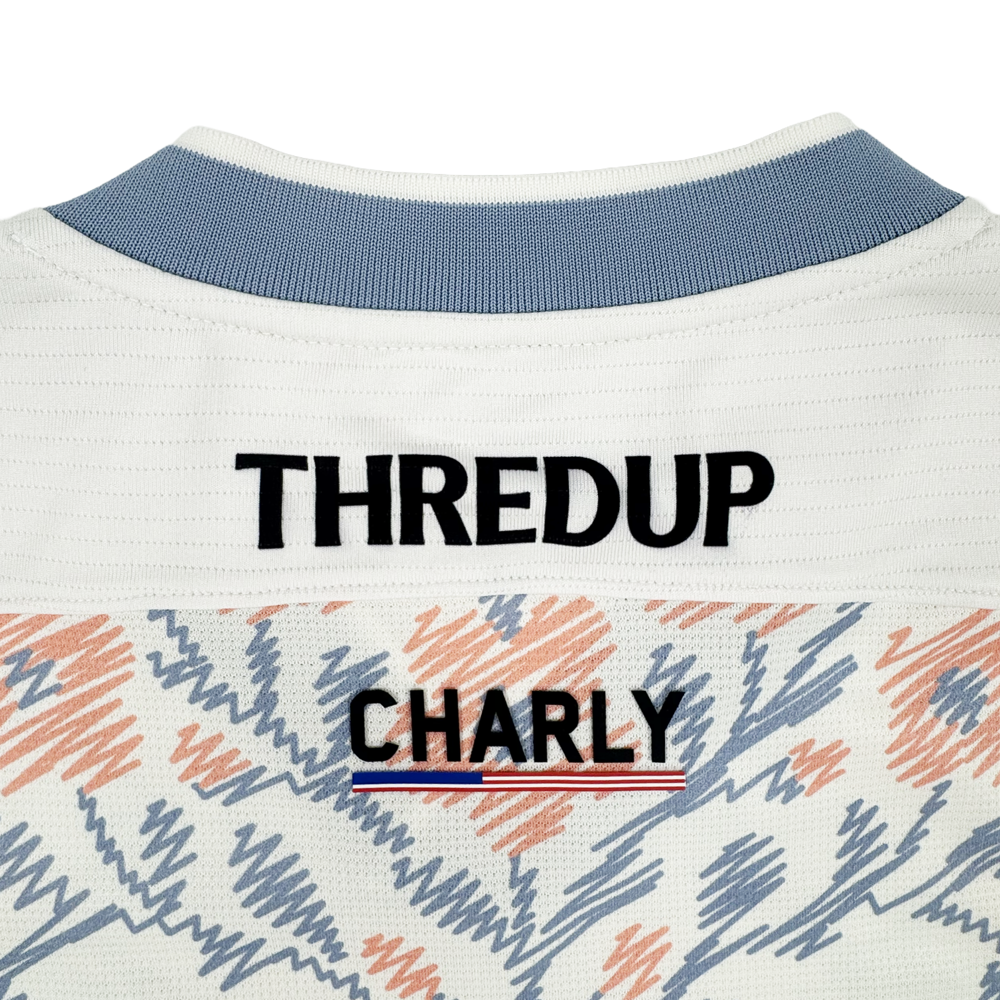 Close-up of the upper back of a white Oakland Soul 2026 SC Form Jersey, crafted from high-quality polyester. "THREDUP" is in bold black above "OAKLAND SOUL," with a red, white, and blue stripe and abstract orange and blue accents.