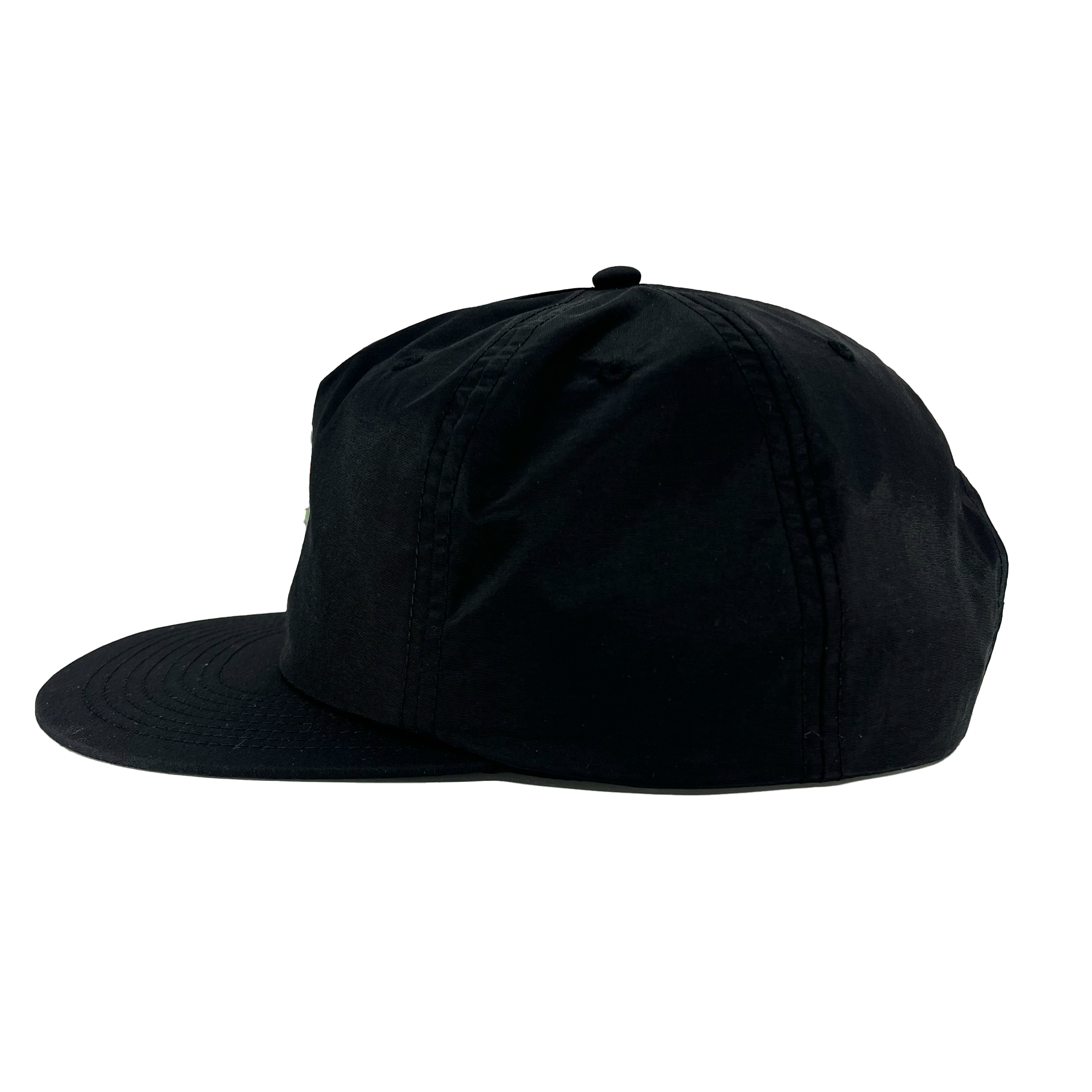 A side view of the Oakland Soul Surf Cap is depicted against a white background. This black cap features a flat brim and a structured crown, complemented by a button on top and stitch detailing along the seams and brim. Reflecting the dynamic spirit of Oakland Soul in the USL W-League, the cap appears plain with no visible logos or designs.