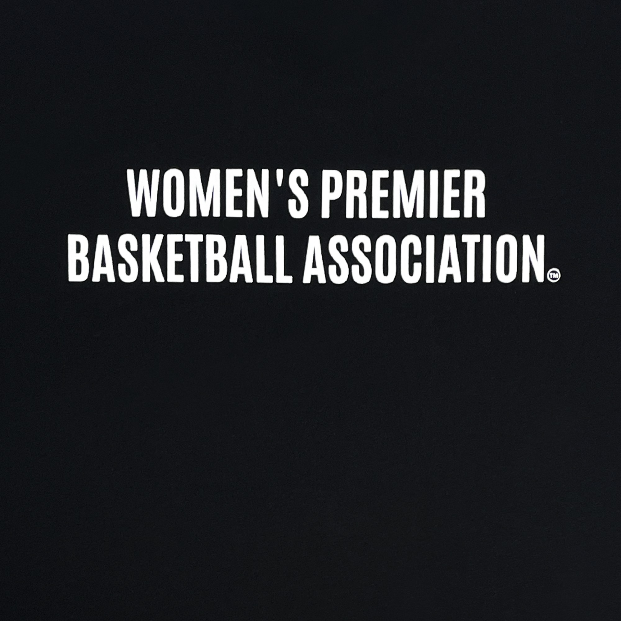 Detailed back view of black WPBA tee with Women's Premier Basketball Association wordmark logo in white.