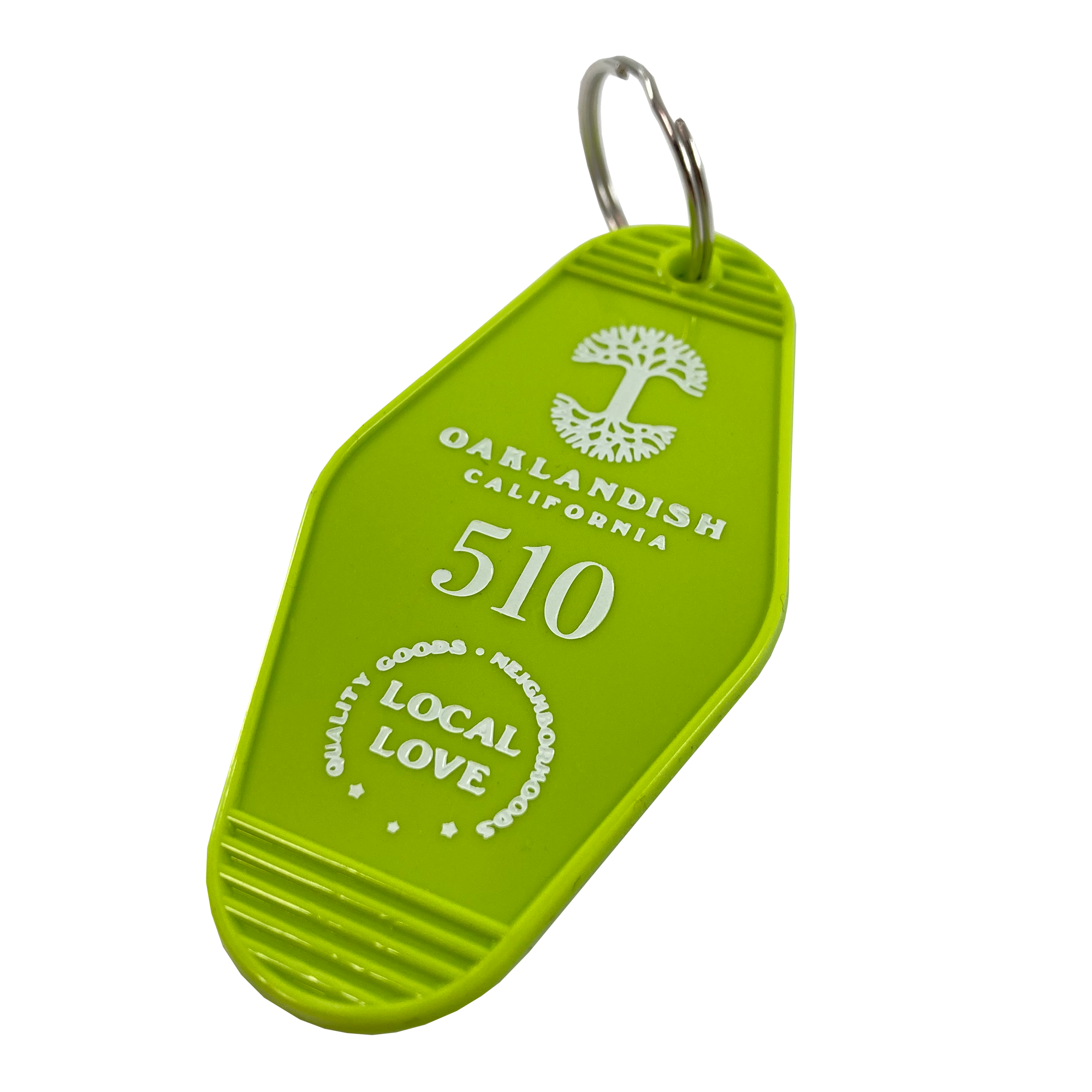 The "Local Love Key Tag" by Oaklandish is a vibrant green keychain styled like a vintage motel key tag. It displays "Oaklandish California, 510" alongside a tree logo at the top. Below, it reads "Local Love," encapsulated by the words “QUALITY GOODS + NEIGHBORHOOD PRIDE." This distinctive accessory features a small metal key ring for attaching your keys.