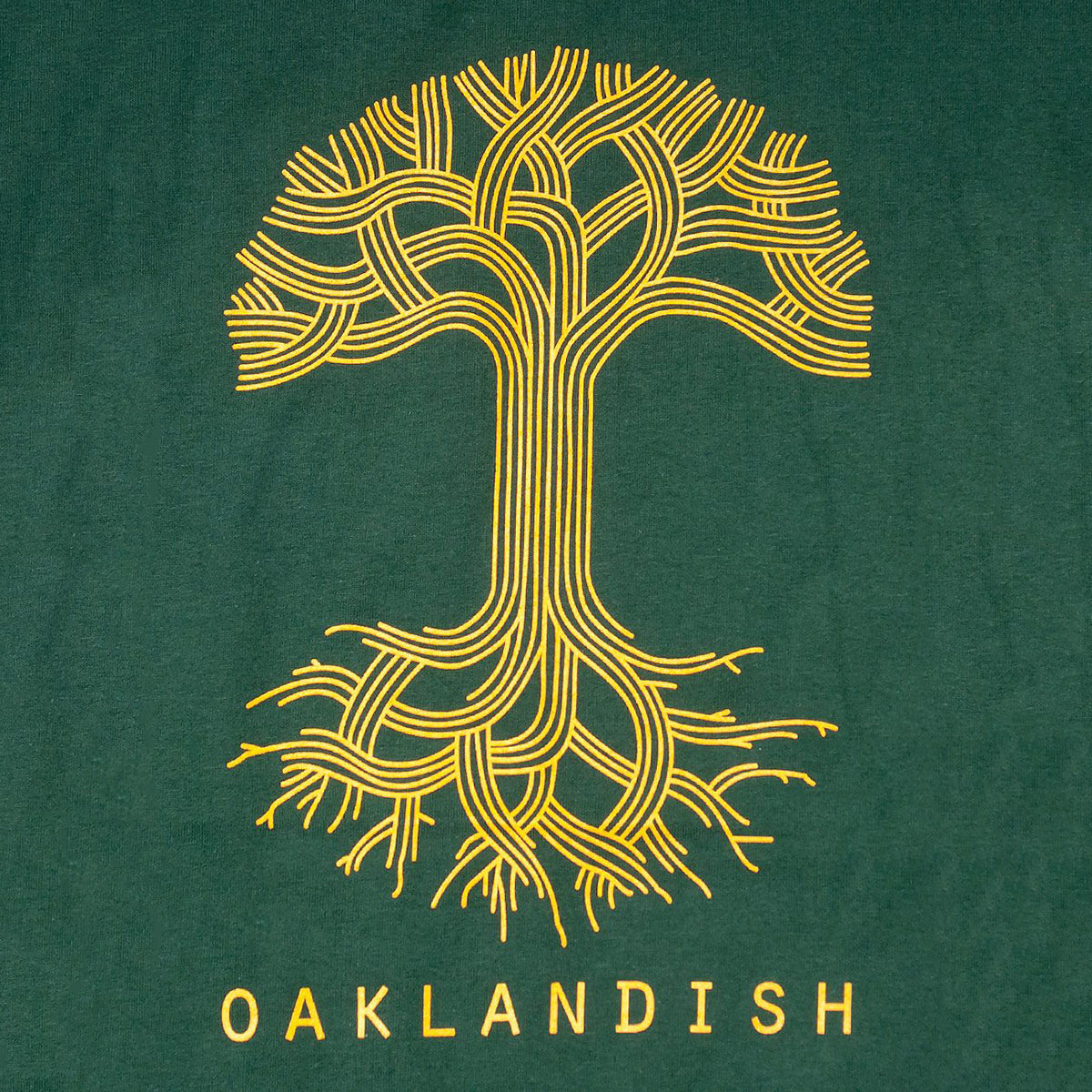 The Oaklandish Classic Logo Tee by Oaklandish features a stylized yellow tree with intertwined branches and roots, creating a symmetrical design. The tree is set against a dark green background. Below the tree, "OAKLANDISH" is written in yellow capital letters on a classic fit t-shirt made of 100% cotton.