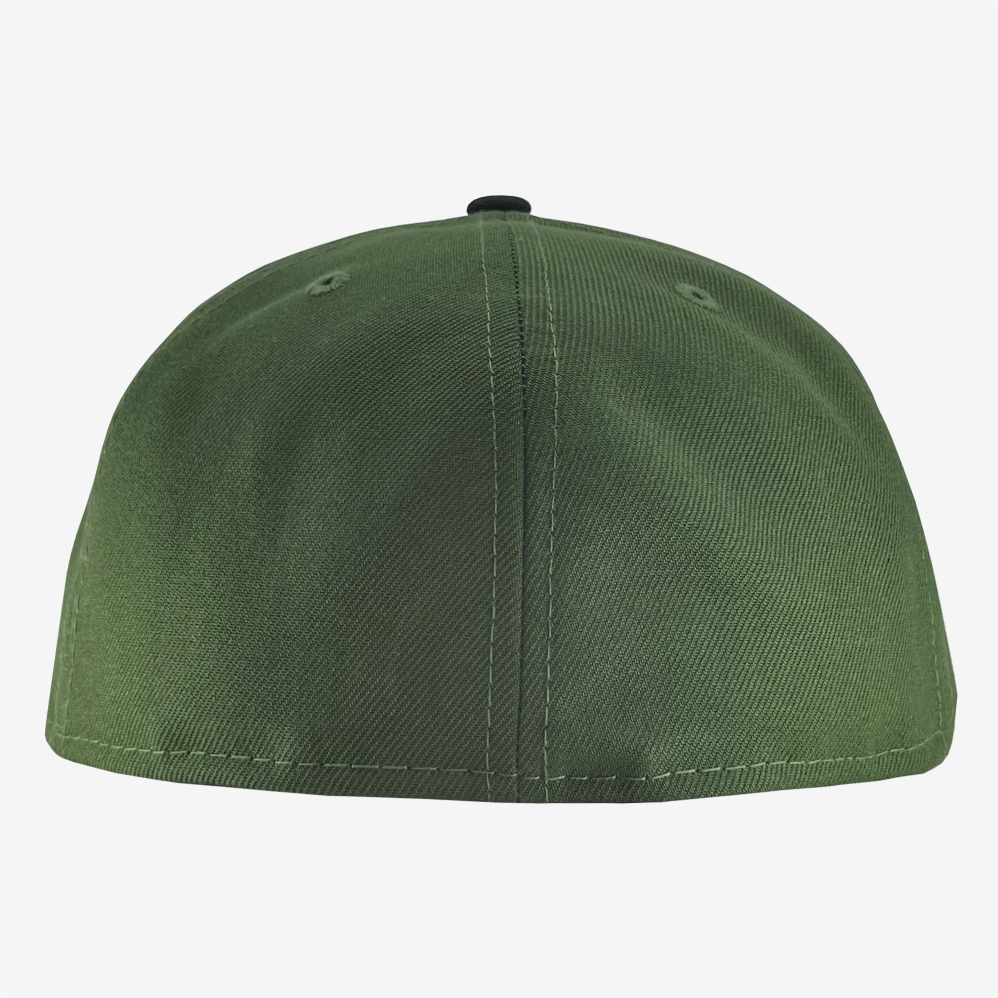 The image shows the back view of a green New Era Official 59FIFTY Fitted Cap. The cap has a smooth, unadorned surface with visible stitching and two small ventilation holes. There is no adjustment strap; the hat appears to be a fitted style. This sleek Oaklandish design features top-notch quality on a plain white background.