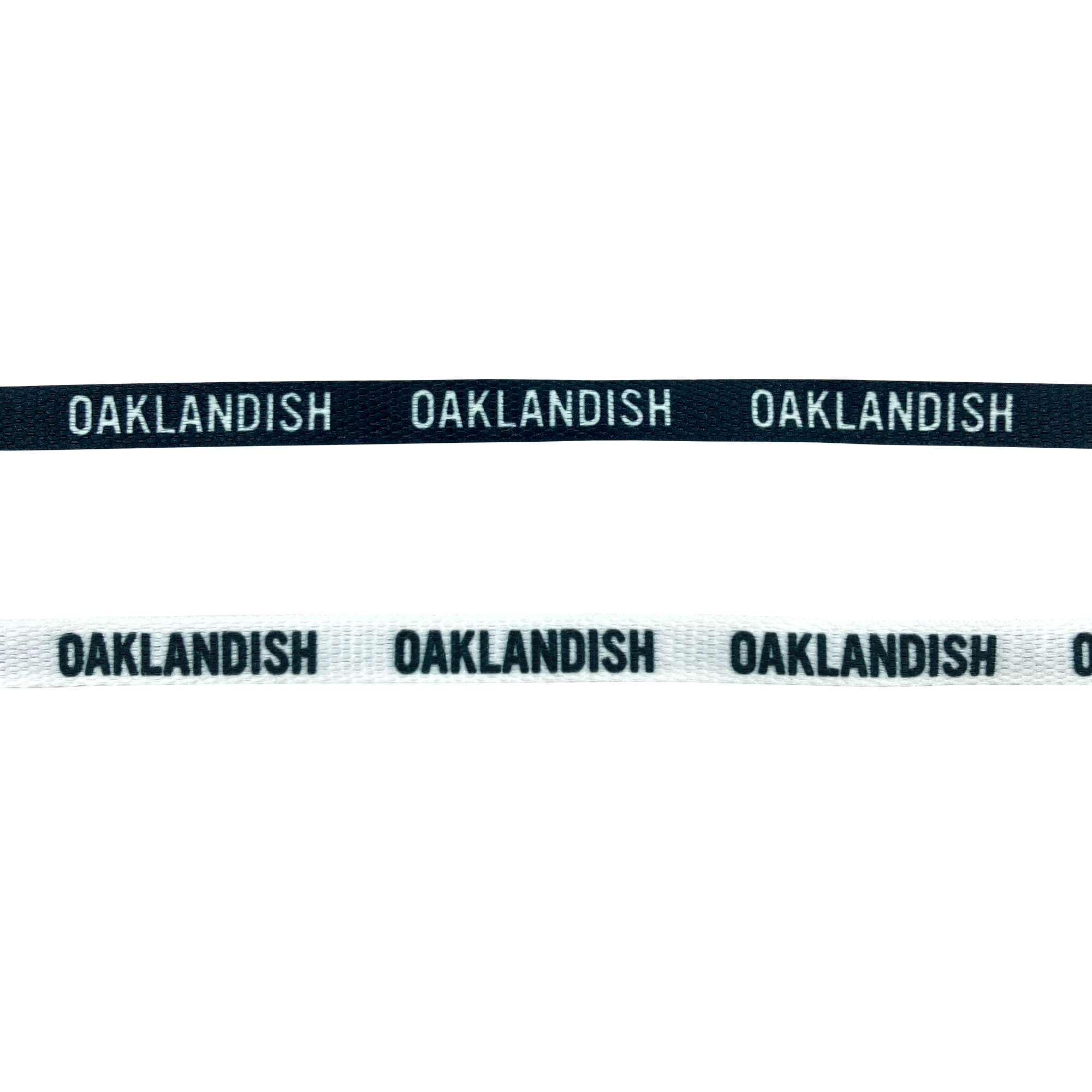 Close-up of two Wordmark Shoelaces by Oaklandish, featuring the text "OAKLANDISH" repeated. The top shoelace has a black background with white text, while the bottom shoelace has a white background with black text. Both shoelaces boast a unique design above the text, reminiscent of woven labels.