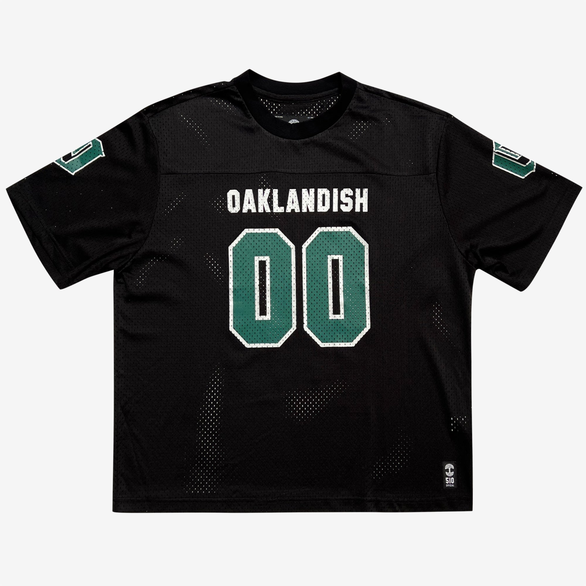 The Official Football Home Jersey by Oaklandish is a black short-sleeve jersey made from lightweight mesh to boost breathability. The front prominently features the number "00" in large white and green digits, with "OAKLANDISH" in white uppercase letters above it. Both sleeves also display the number "00." At the bottom right hem, a woven label reads "100 OAK.