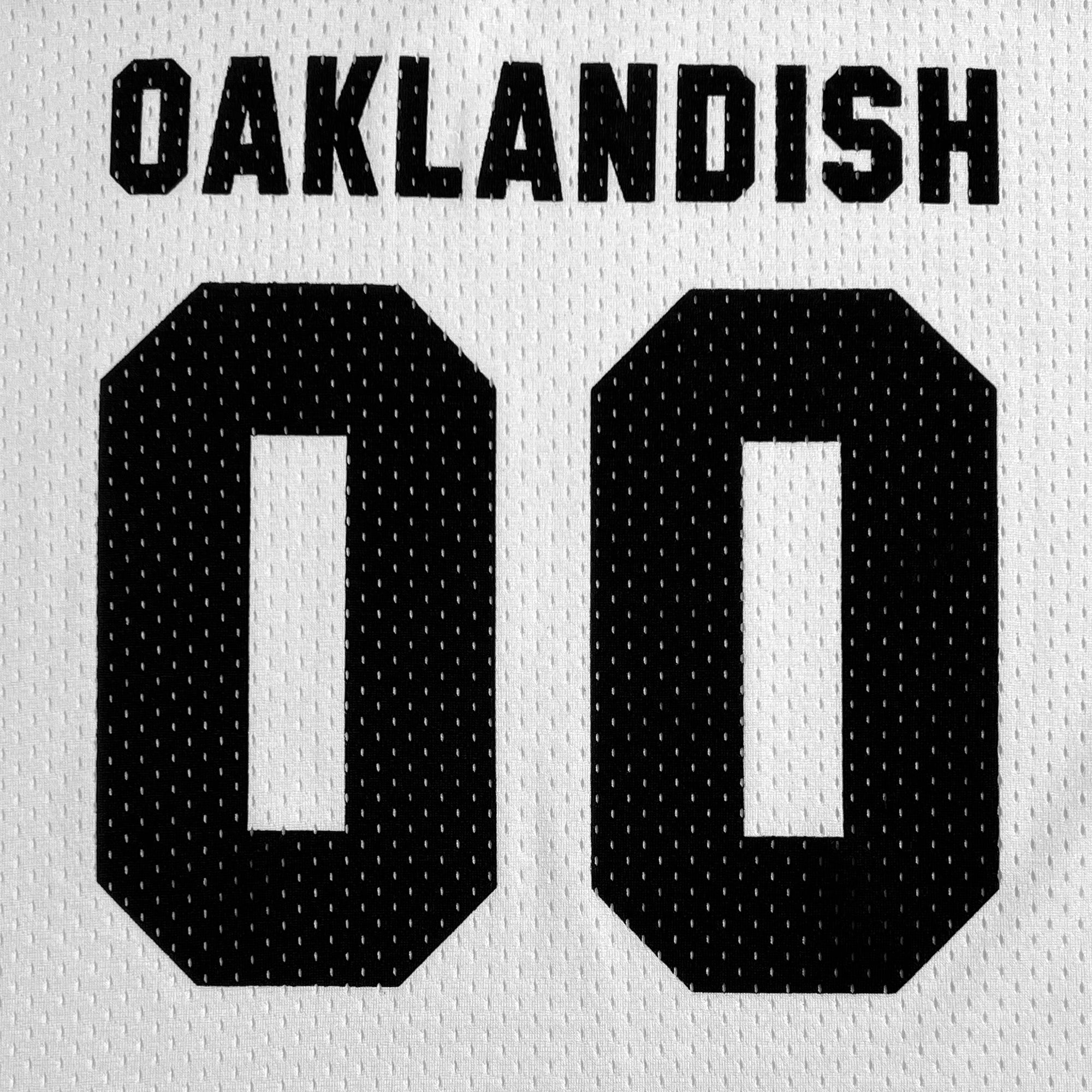 A close-up image of the Official Football Away Jersey from Oaklandish, featuring the word "OAKLANDISH" written in bold black letters at the top. Below this, the number "00" is prominently displayed in large black digits. The lightweight mesh material gives the jersey a slightly perforated texture.