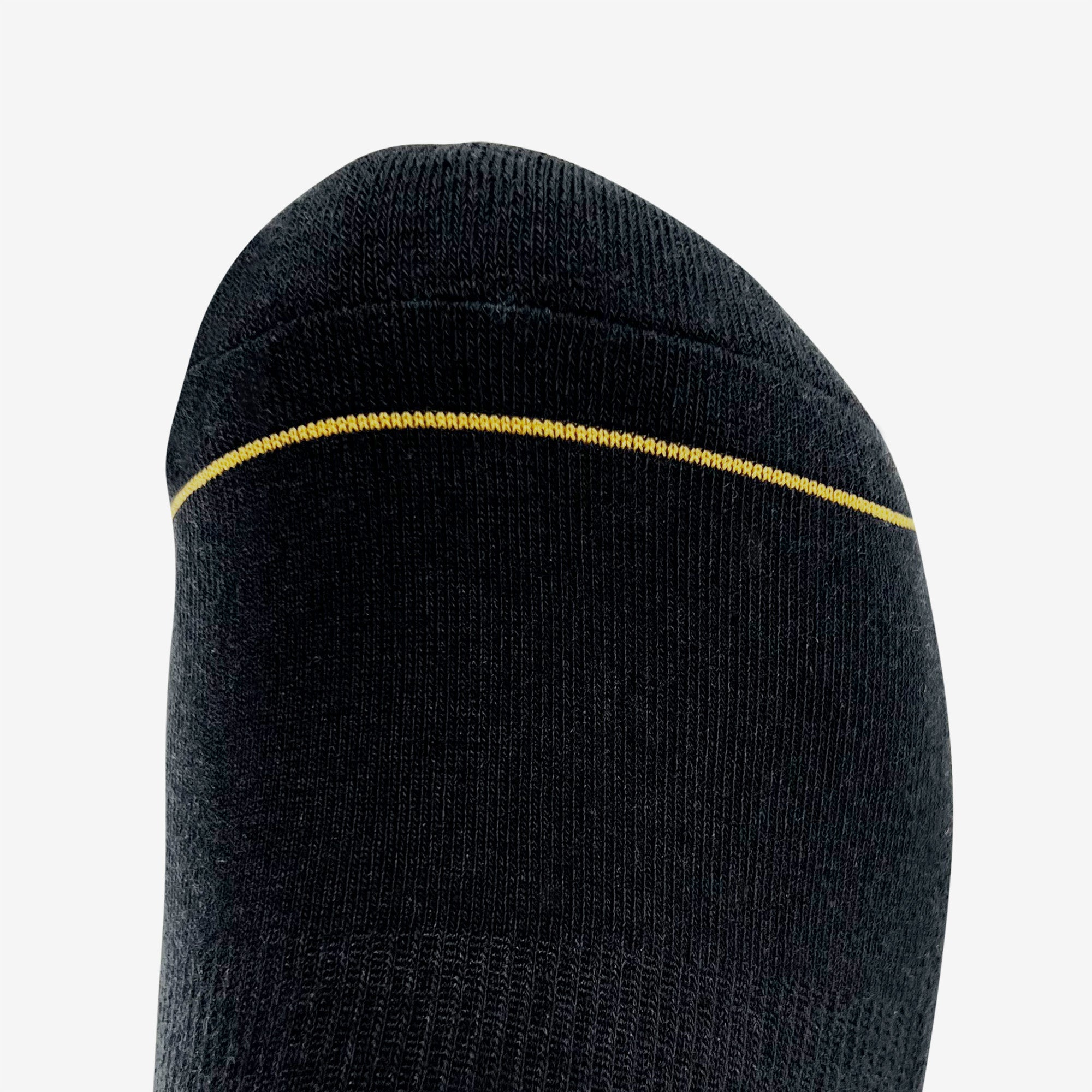 Close-up view of the toe section of the black/gold Embroidered Logo Sock by Oaklandish, showcasing a seamless design. A single, subtle yellow line runs horizontally near the top edge, contrasting with the black fabric. The sock has a smooth knit texture and a slightly rounded shape at the tip. Available in adult sizes.