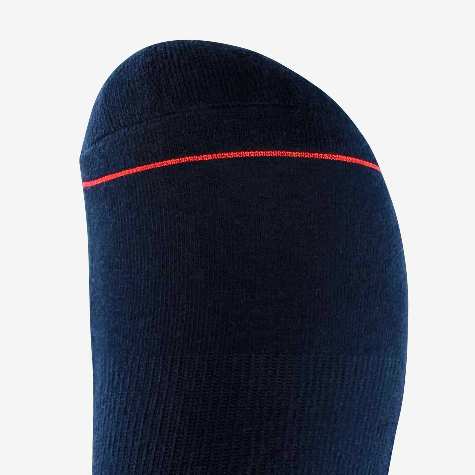 A close-up shot features an Embroidered Logo Sock by Oaklandish, showcasing a dark-colored sock enveloping a foot and highlighting the toe area. This crew sock is solid black with a fine horizontal red stripe near the toes and appears to have a subtly ribbed texture. Adorned with the iconic Oaklandish logo, these socks are available in adult sizes. The background is plain light grey, emphasizing the sleek design of the sock.