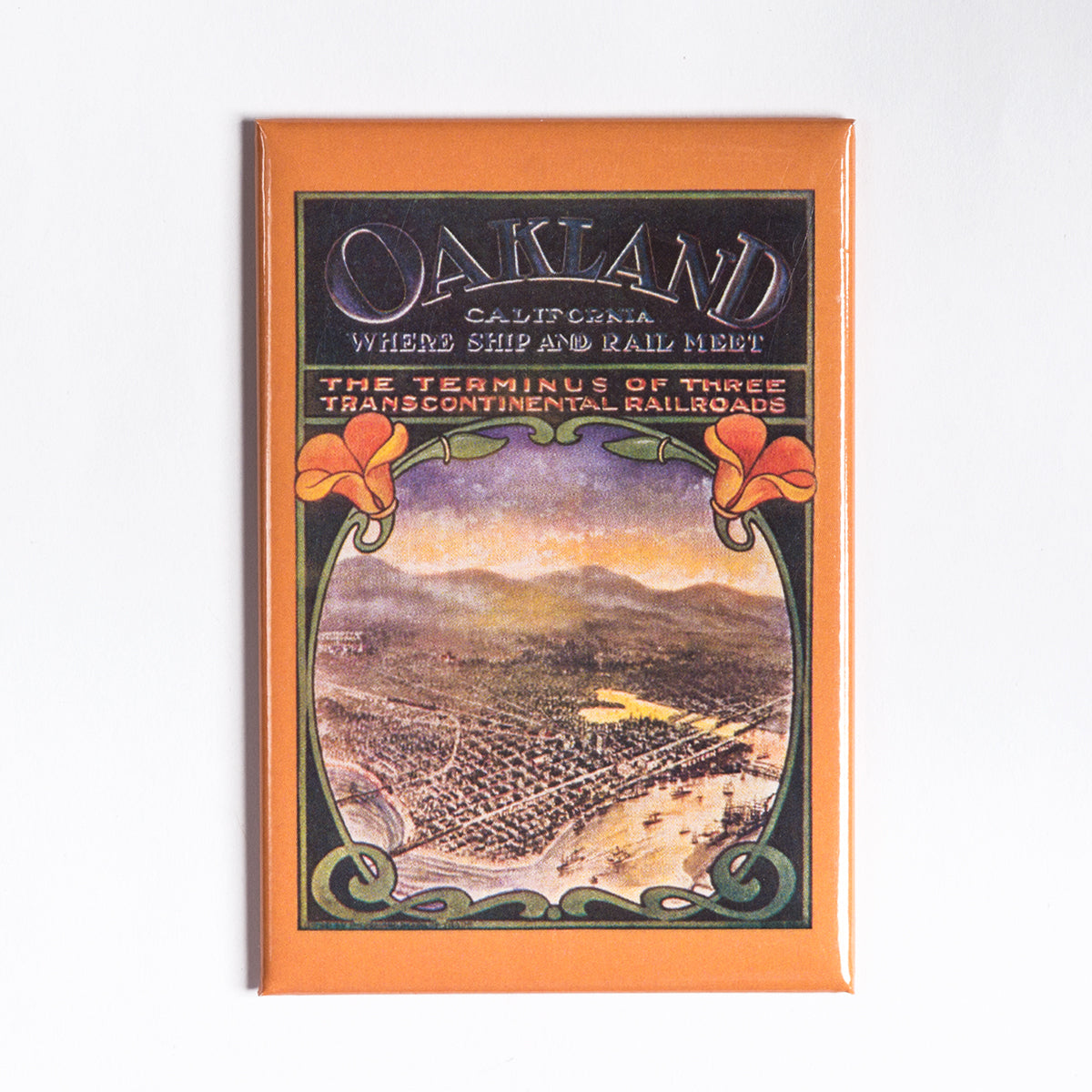 The Poppies Magnet, created by Oaklandish, is a vintage-inspired piece ideal as an Oakland souvenir or refrigerator magnet. It showcases "Oakland, California: Where Ship and Rail Meet," highlighting an illustrated aerial view of a lively city featuring various buildings and an extensive rail network. The magnet is elegantly bordered with ornate designs and stylized flowers at the top corners.