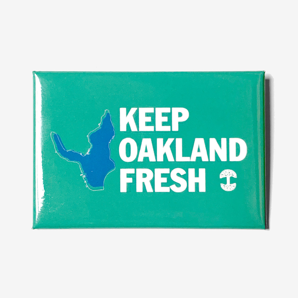 Description: A rectangular teal magnet from Oaklandish displaying "KEEP OAKLAND FRESH" in white capital letters. To the left of the text is an outline of Oakland in dark blue, and to the right, a small white anchor graphic completes this trendy accessory.