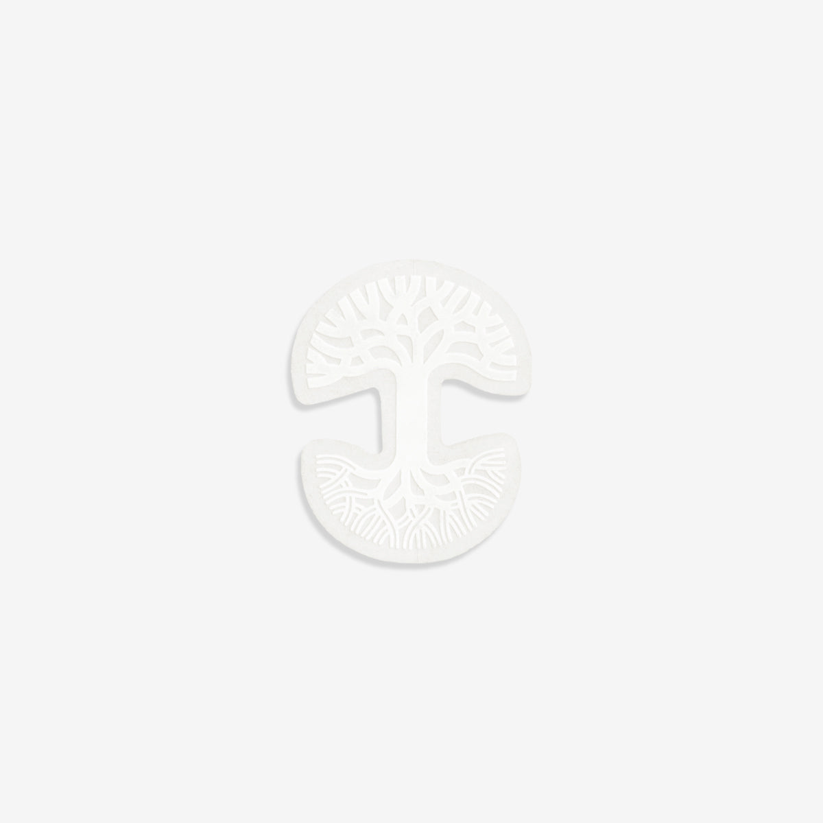 The Oaklandish Decal 1 1/2 X 2 by Oaklandish is a white, round porcelain object with intricate, tree-like patterns etched into the surface. It is horizontally split, displaying mirror-image designs of trees with expansive branches and root systems on both the top and bottom halves. The plain white background makes it a perfect addition for an Oakland window decal.